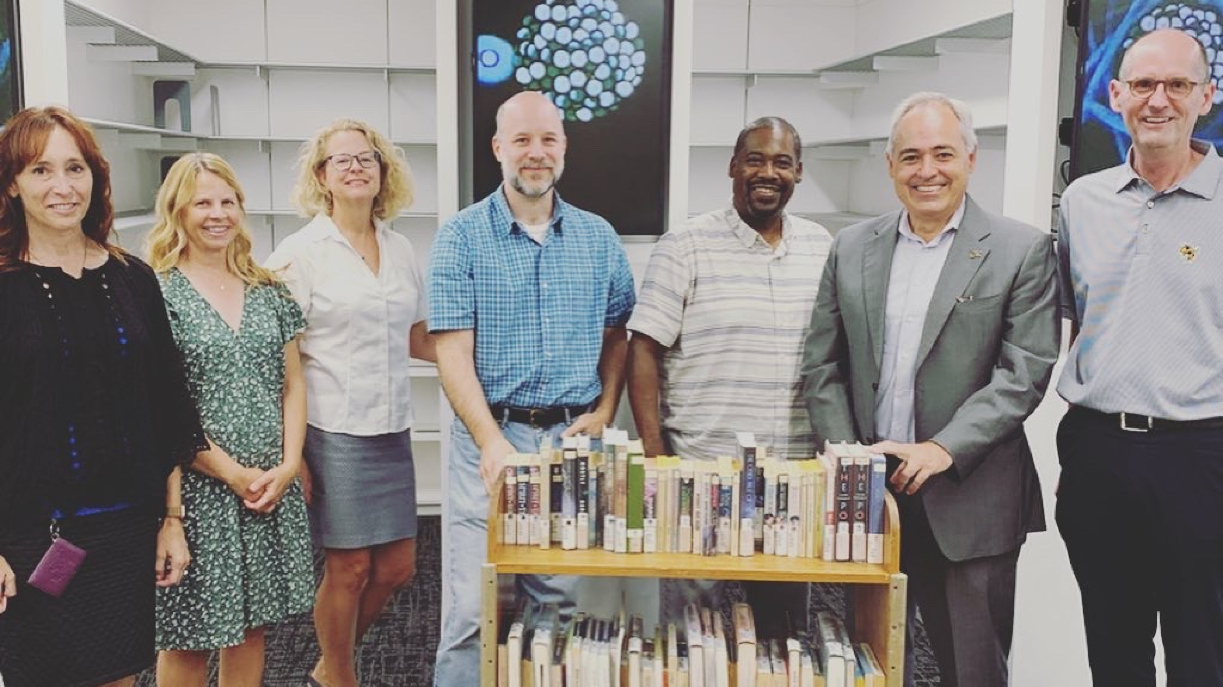 Institute and Library representatives with books