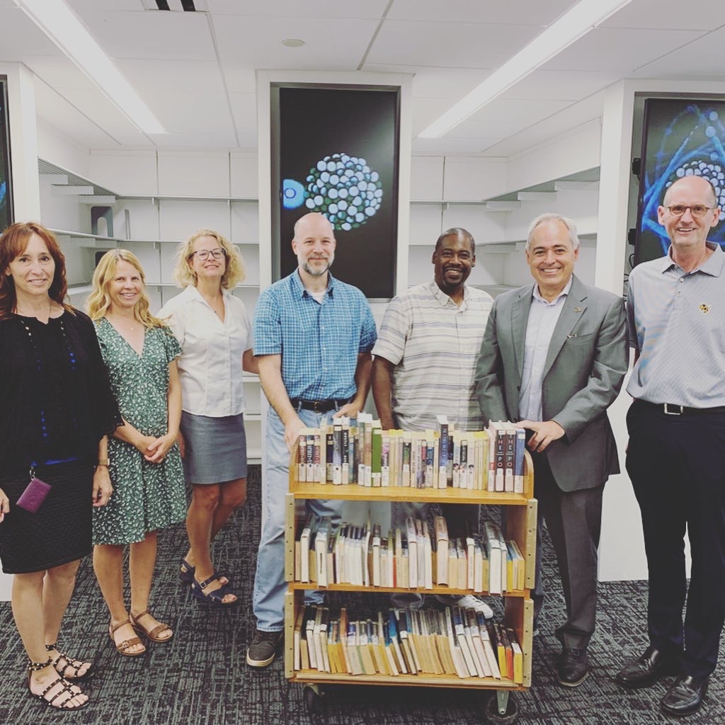 Institute and Library representatives with books